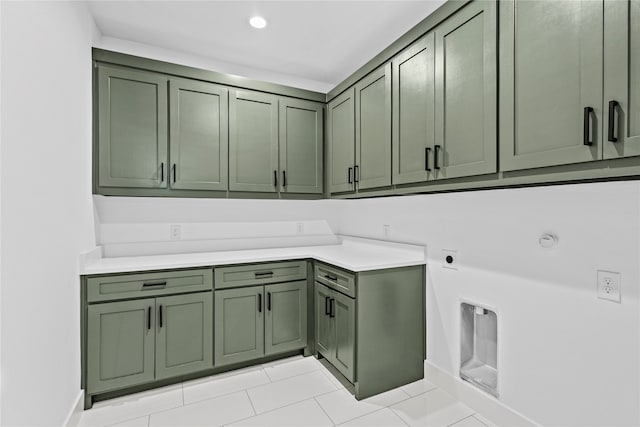 laundry room with cabinets, light tile patterned floors, and hookup for an electric dryer