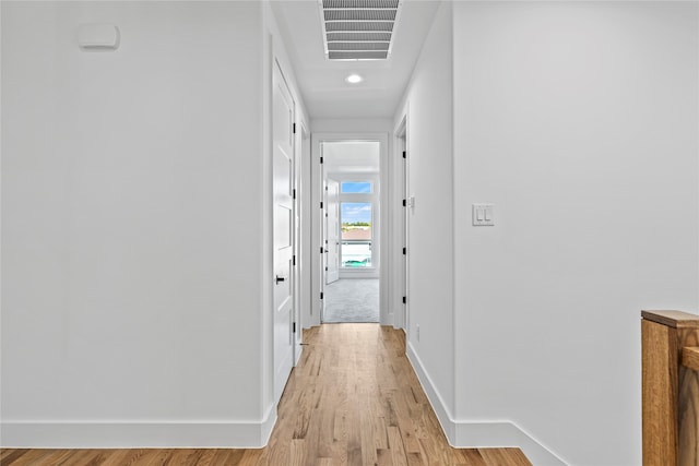 corridor with light hardwood / wood-style flooring