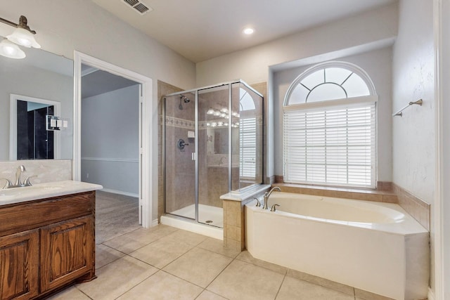 bathroom with tile patterned flooring, plenty of natural light, separate shower and tub, and vanity