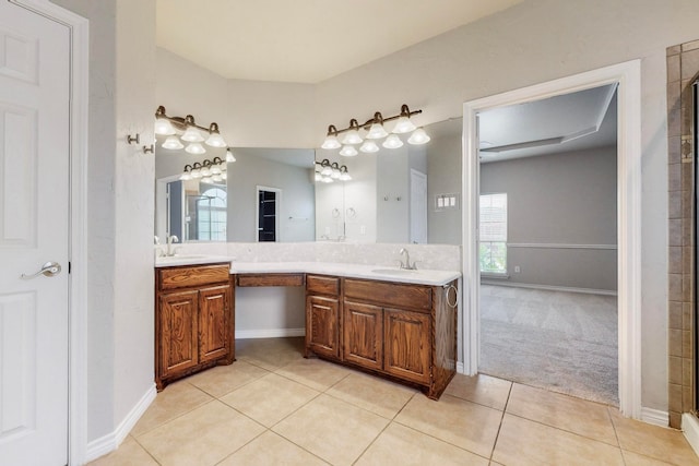 bathroom with tile patterned floors, vanity, and a shower with door