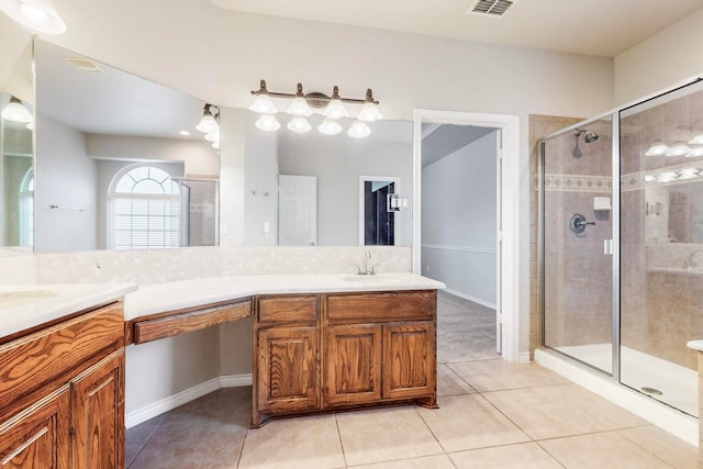 bathroom featuring tile patterned floors, vanity, and walk in shower