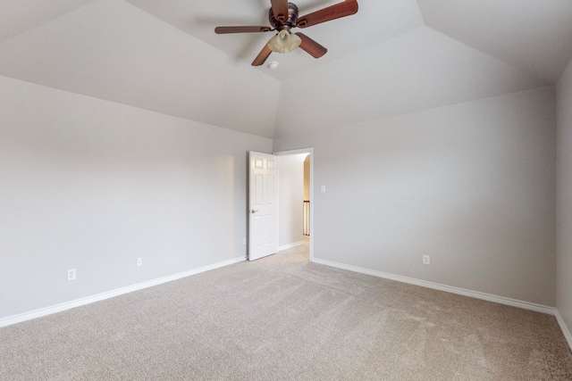 empty room with ceiling fan, lofted ceiling, and light carpet