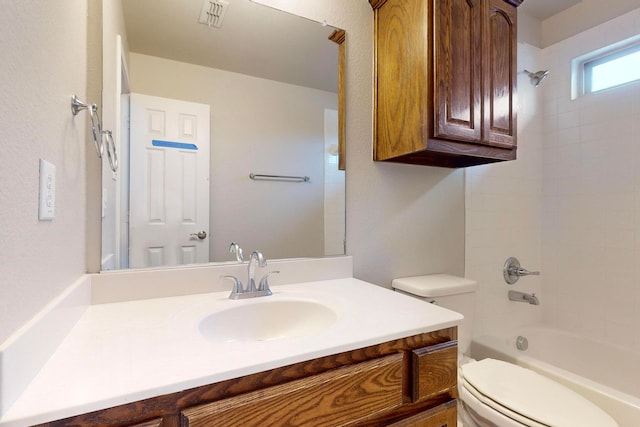 full bathroom featuring toilet, vanity, and tiled shower / bath combo