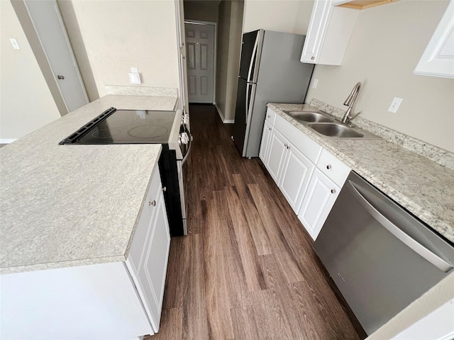 kitchen with white cabinets, appliances with stainless steel finishes, dark hardwood / wood-style flooring, and sink