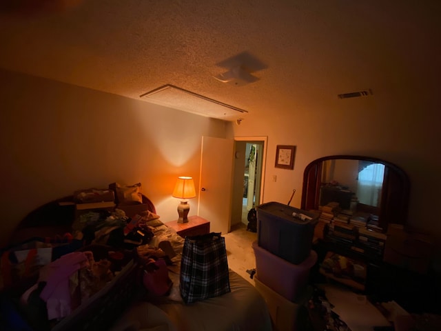 bedroom featuring light carpet and a textured ceiling