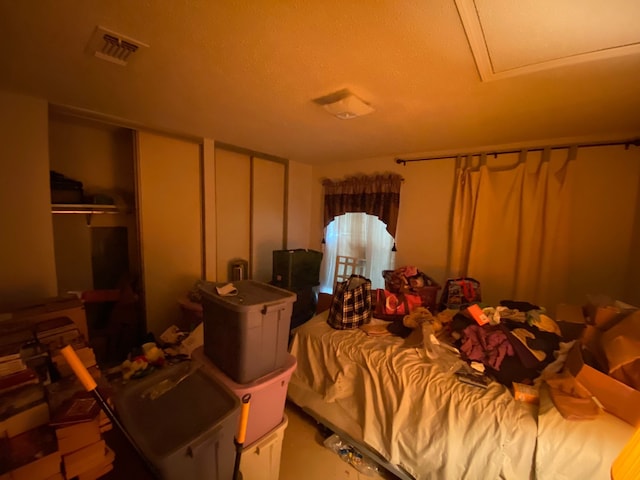 bedroom featuring a textured ceiling and multiple closets