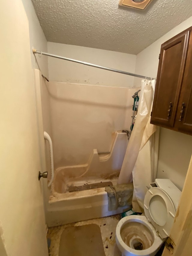 bathroom with toilet, a textured ceiling, and walk in shower