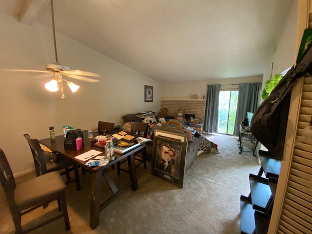 carpeted dining space featuring ceiling fan, beam ceiling, high vaulted ceiling, and a brick fireplace