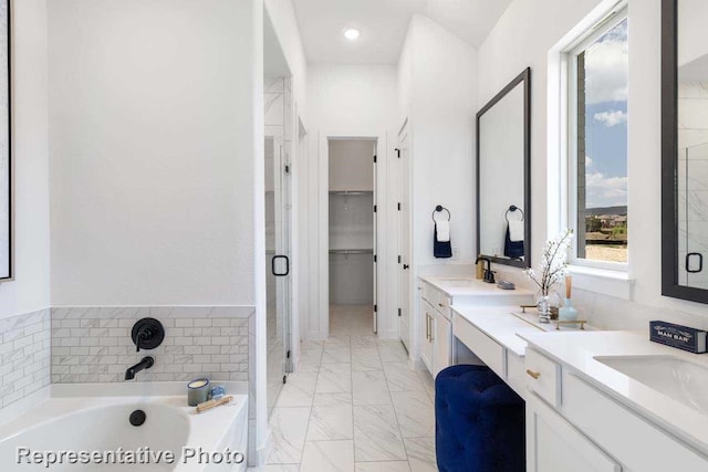 2166 Charming Forge Rd, Forney, TX 75126 - bathroom featuring double vanity, marble finish flooring, a garden tub, a shower stall, and a spacious closet