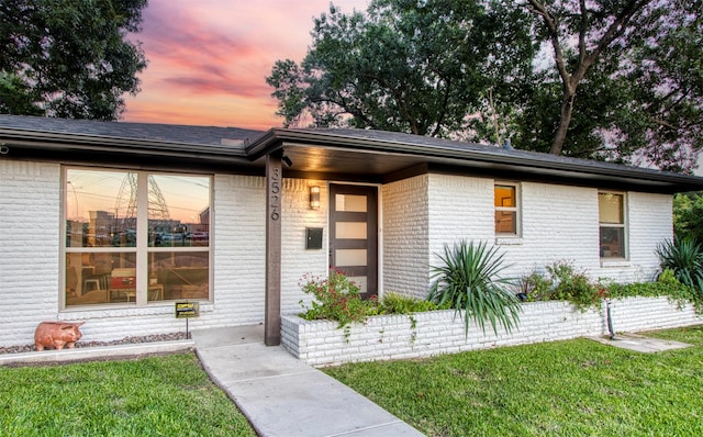 view of front of home with a lawn