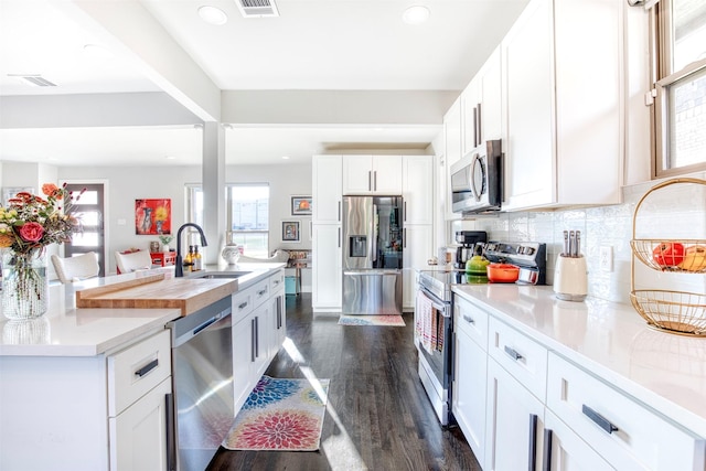 kitchen featuring white cabinetry, stainless steel appliances, dark hardwood / wood-style floors, and sink