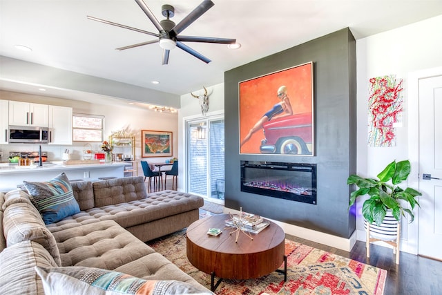 living room featuring hardwood / wood-style floors and ceiling fan