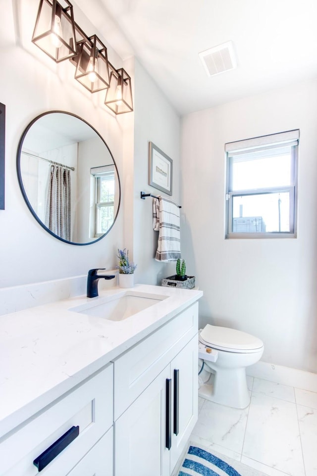 bathroom with vanity and toilet