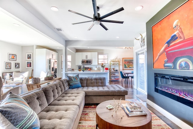 living room with ceiling fan and wood-type flooring