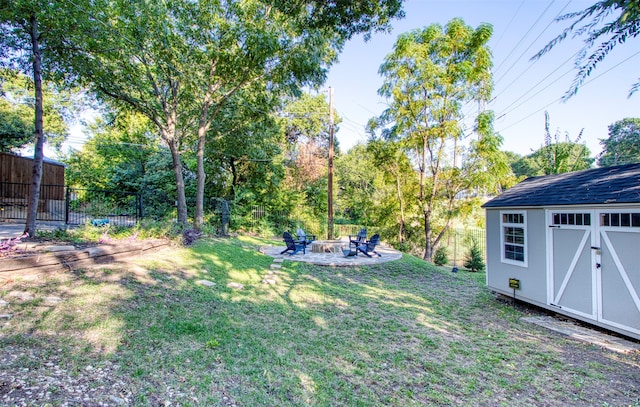 view of yard with a storage unit and a fire pit