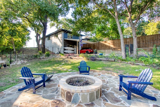 view of patio / terrace featuring an outdoor fire pit