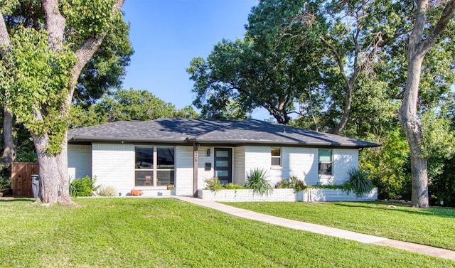 ranch-style home with a front lawn