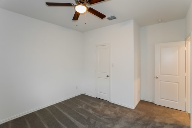 unfurnished bedroom featuring dark colored carpet and ceiling fan