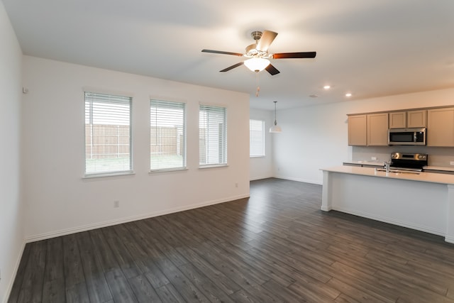 kitchen featuring decorative light fixtures, stainless steel appliances, ceiling fan, and dark wood-type flooring