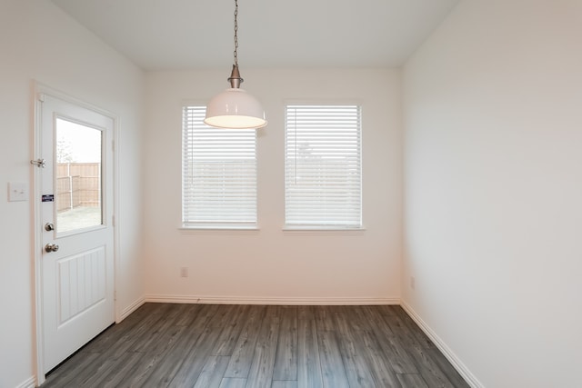 unfurnished dining area featuring dark hardwood / wood-style flooring