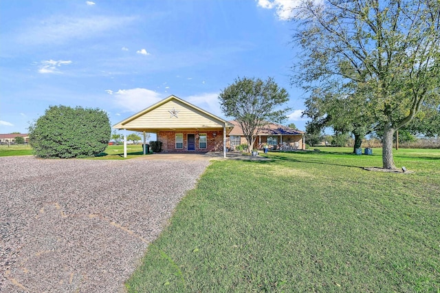 239 W Line Rd, Whitesboro, TX 76273 - ranch-style home with gravel driveway, a front yard, a carport, and brick siding