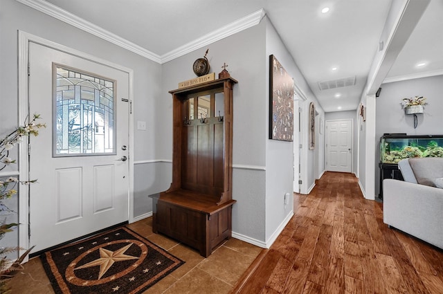 entryway with crown molding and wood-type flooring