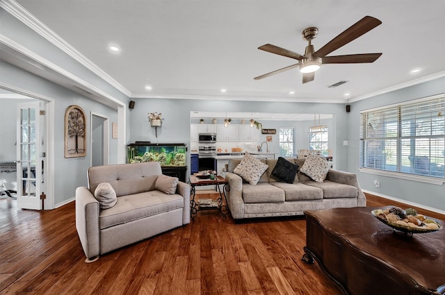 living room with ceiling fan, dark hardwood / wood-style flooring, and ornamental molding