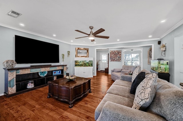 living room featuring hardwood / wood-style flooring, ceiling fan, and crown molding