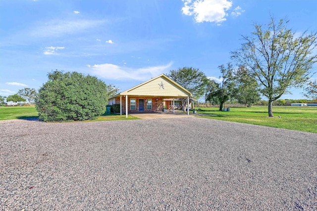 239 W Line Rd, Whitesboro, TX 76273 - view of front of property with an attached carport, a front yard, gravel driveway, and brick siding