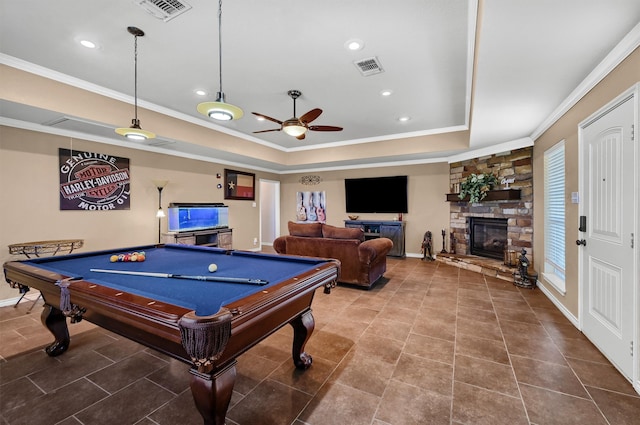 recreation room featuring ceiling fan, a stone fireplace, tile patterned flooring, crown molding, and pool table