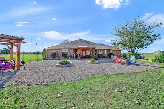 239 W Line Rd, Whitesboro, TX 76273 - back of house featuring a pergola, a patio area, brick siding, and an outdoor fire pit