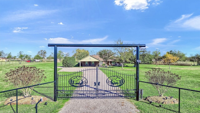 view of gate with a yard