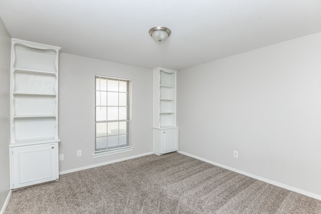 unfurnished room featuring light colored carpet