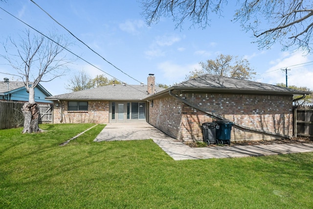 back of house with a yard and a patio