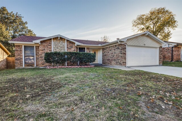 single story home with a front yard and a garage