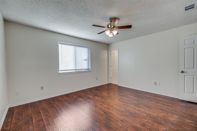 empty room featuring ceiling fan, dark hardwood / wood-style flooring, and a textured ceiling