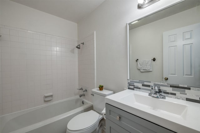 full bathroom with vanity, toilet, tiled shower / bath combo, and backsplash