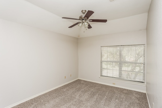 empty room featuring ceiling fan and carpet