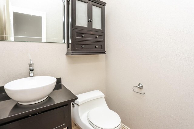 bathroom featuring vanity and toilet