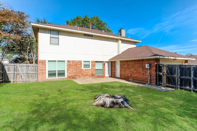 back of property with a lawn and a patio