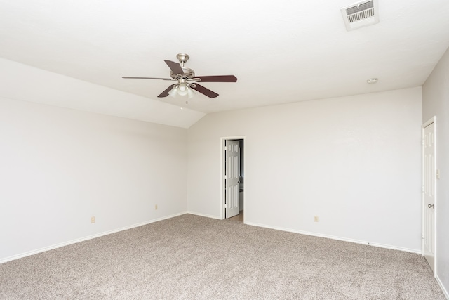 carpeted spare room featuring ceiling fan and vaulted ceiling