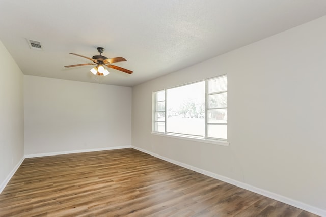 spare room with hardwood / wood-style floors, a textured ceiling, and ceiling fan