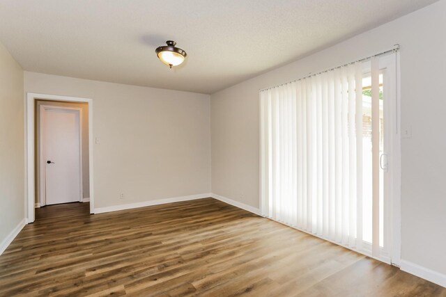 empty room featuring dark hardwood / wood-style flooring