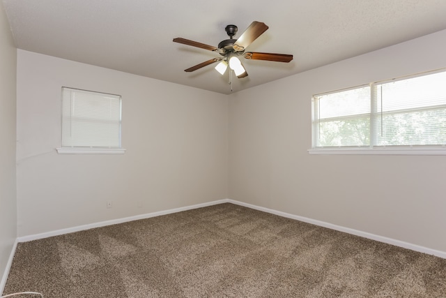 spare room with ceiling fan and carpet floors