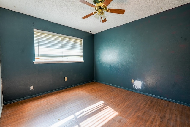 empty room with wood-type flooring, a textured ceiling, and ceiling fan