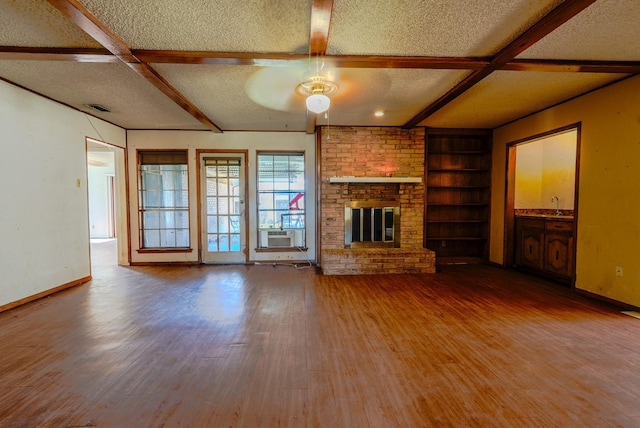 unfurnished living room featuring beam ceiling, a fireplace, and coffered ceiling