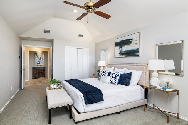 bedroom featuring ceiling fan, a closet, light colored carpet, and vaulted ceiling