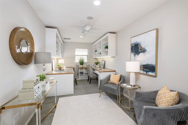 sitting room featuring carpet flooring and ceiling fan