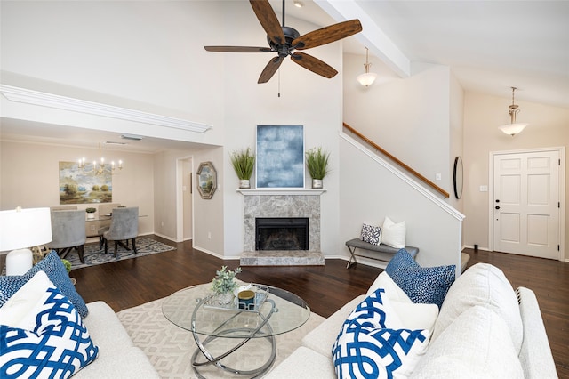 living room featuring ceiling fan with notable chandelier, dark hardwood / wood-style floors, and a premium fireplace