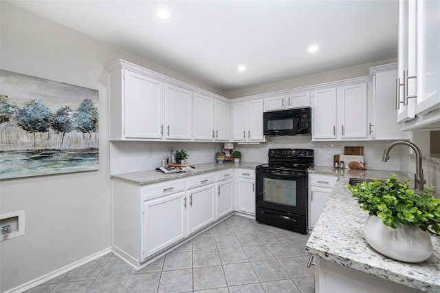 kitchen featuring black appliances, decorative backsplash, and white cabinetry